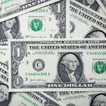 Stack of dollar bills, representing fast payouts, a feature that can be found in Betpack's list of sites.